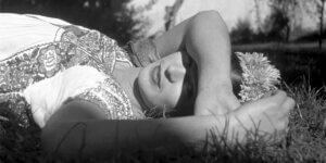 Frida kahlo lying down on grass from New Frida Documentary Unveils the Artist’s own Perspective, voiced by Mexican actor Fernanda Echevarría del Rivero