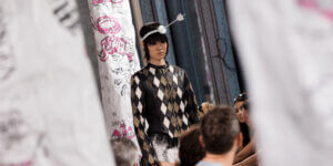Model walks in SF1OG’s Berlin Fashion Week show wearing a harlequin leather jacket and Cupid-inspired headpiece, designed by Rosa Marga Dahl.