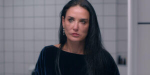 Demi Moore in The Substance, crying in a bathroom, symbolizing beauty, aging, and the rise of facelifts in Guadalajara.