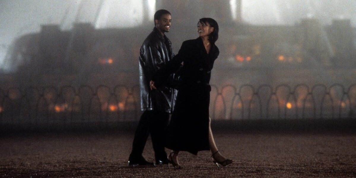 Scene from Love Jones (1997) featuring actors Larenz Tate and Nia Long walking together at night, symbolizing modern Black love and romance in 90s cinema.
