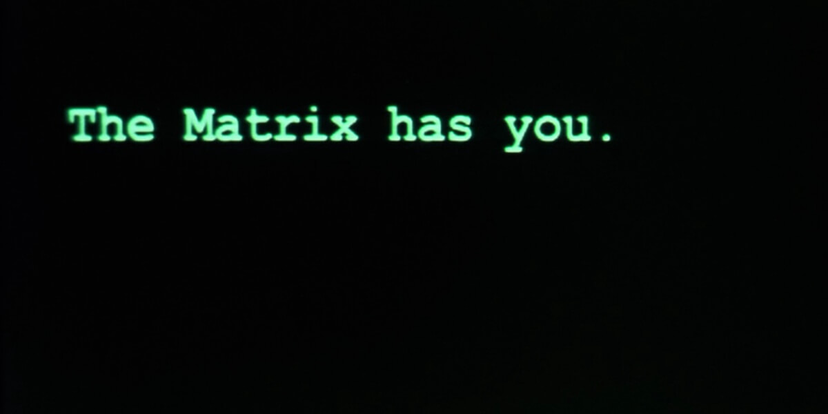 Green computer-style text reading “The Matrix has you” on a black screen, referencing digital control and AI themes.