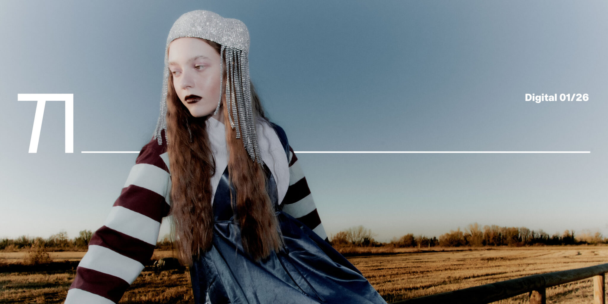 Fashion editorial set in the Italian countryside featuring a model in a soft knit look and statement accessories, styled against winter fields with a floral headpiece, photographed by Pietro Groff.