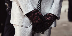 Close-up of John Lawrence Sullivan AW26 menswear look featuring silver tailored suit and black mesh gloves inspired by boxing at Berlin Fashion Week