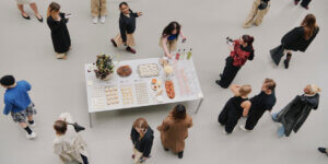 Wide shot of the On Style Lab event in Berlin showcasing the On x Zendaya collection, with creatives styling versatile wardrobe essentials in a collaborative fashion space