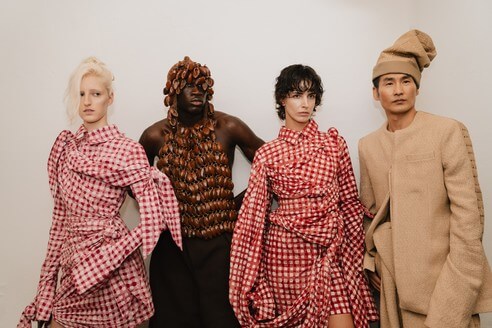Frank Aghuno presents Fruché SS27 "KLEG" at Berlin Fashion Week, showcasing Nigerian craftsmanship, Adire textiles, Gingham fabrics, and contemporary African fashion.