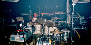 Stage setup with drum kit, keyboards, microphones and live sound equipment at J.A.W. Family's 20th Anniversary Family Reunion festival at 90mil in Berlin.