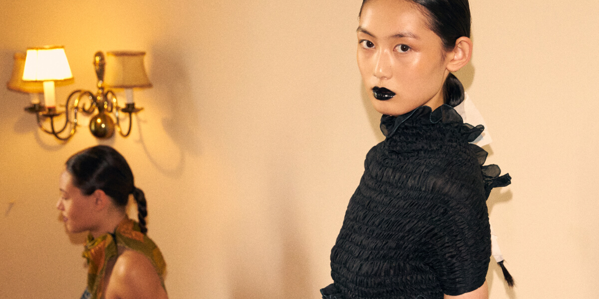 Model wears Laura Gerte Spring/Summer 2027 "Lost to Virtue" runway look at Berlin Fashion Week, showcasing sustainable fashion made from reclaimed and deadstock materials.