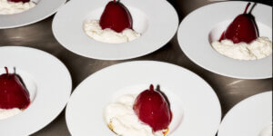 Identical plated desserts prepared for restaurant service, illustrating foodification, food tourism, and the commercialization of urban food culture.