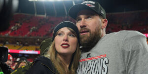 Pop star and professional football player posing together at a football stadium